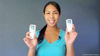 photograph of reviewer and writer vanessa smiling and holding up two bottles of aloe cadabra lube