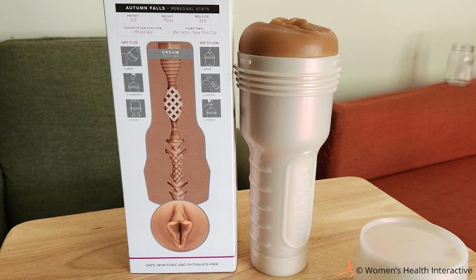 photograph of the autumn falls fleshlight standing up beside its box on a wooden tabletop