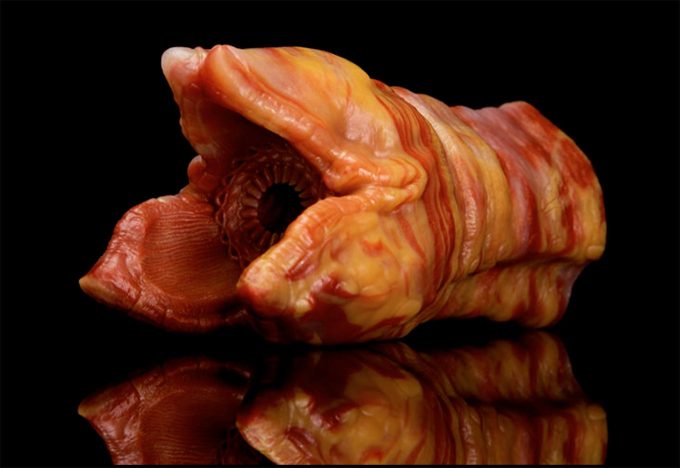 product photo of a bad dragon fantasy masturbation sleeve featuring an alien-like tentacle in shades of orange and red