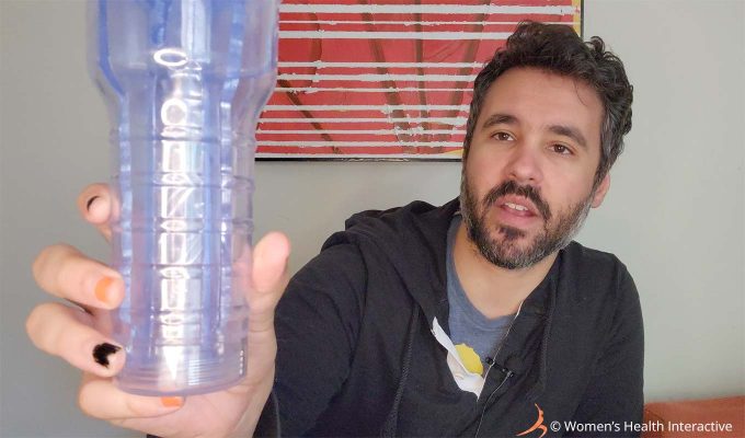 photograph of product tester justin holding the fleshlight turbo thrust ice in his hand to show the clear design of its case