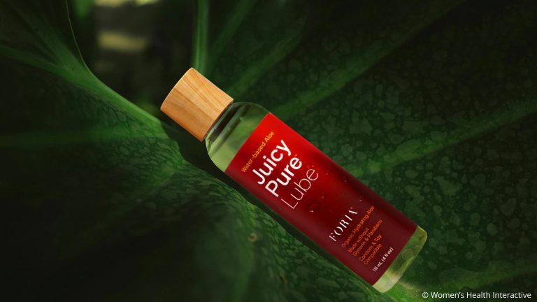 bottle of juicy pure water-based lube resting in the crevice of a giant leaf as the best anal lube