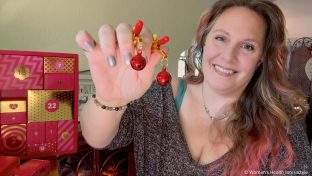 sex toy tester alison holding jingle bell nipple clamps next to a sexy advent calendar