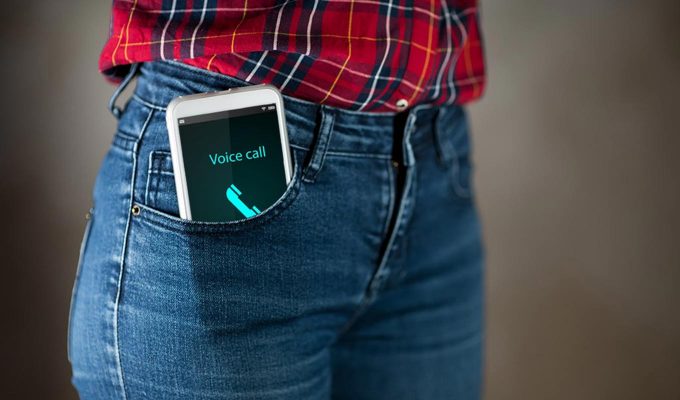 Hip-Level Photograph Of Woman With Cell Phone In Front Jeans Pocket