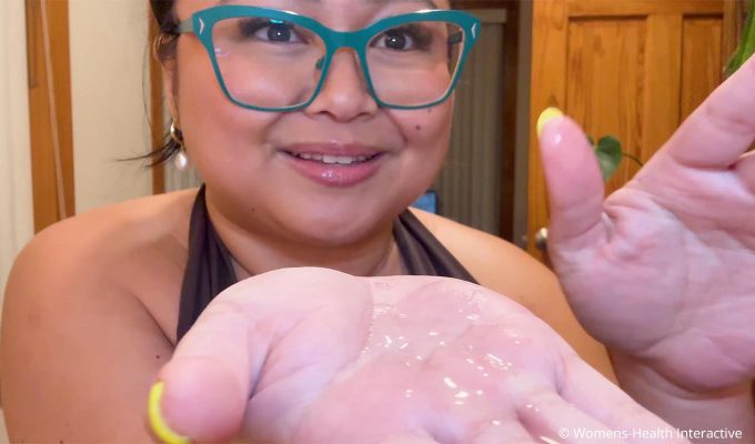 clarisse showing foria juicy pure lube on her hands to demonstrate lightweight slippery feel