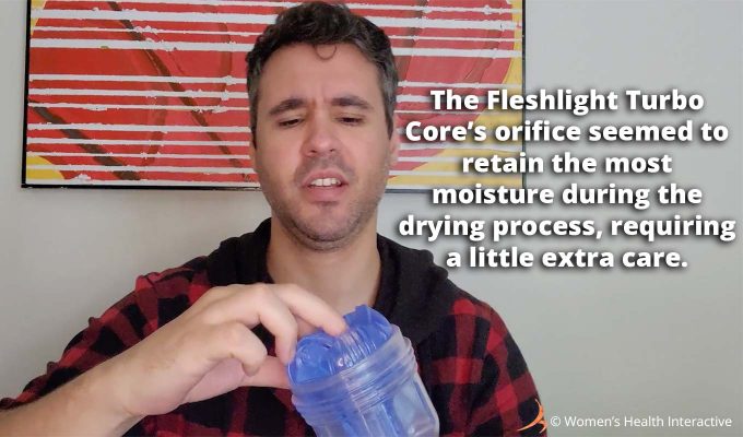 photograph of product tester justin making a face while feeling the orifice of the fleshlight turbo core with text overlay that reads: the fleshlight turbo core's orifice seemed to retain the most moisture during the drying process, requiring a little extra care