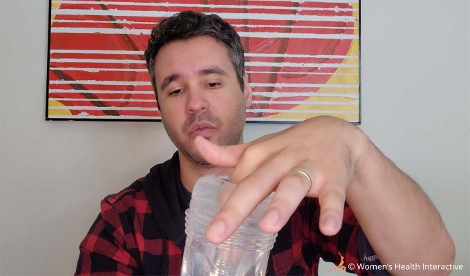 photograph of product tester justin pushing one finger into the orifice of the clear transparent fleshlight go torque ice lady stroker and pocket pussy
