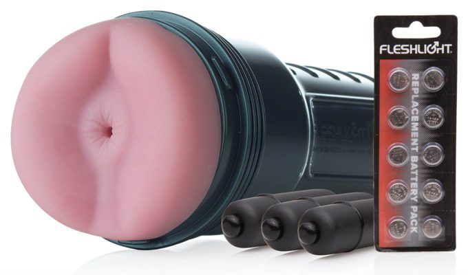 photograph of the fleshjack vibro butt with bullet vibrators and a pack of batteries beside it