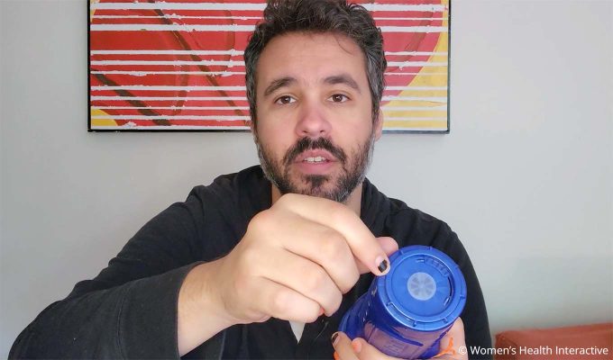photograph of product tester justin holding the boost blow mouth fleshlight to display its air flow dial at the bottom of the case for controlling suction during use