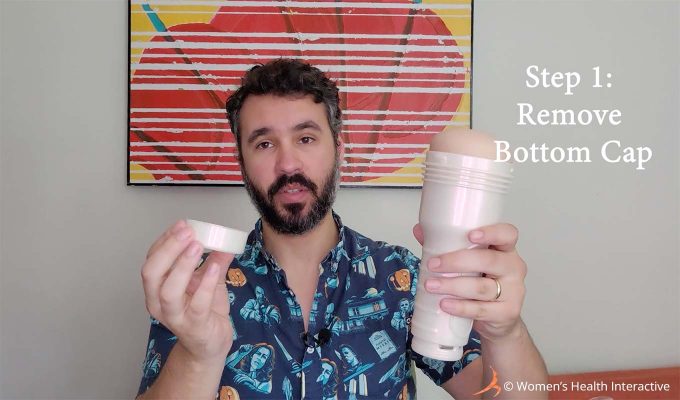 photograph of justin holding a fleshlight in one hand and its bottom cap in the other with text overlay that reads: step 1: remove bottom cap
