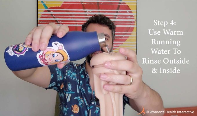 photograph of justin pouring water through a fleshlight sleeve with text overlay that reads: step 4 use warm running water to rinse outside and inside