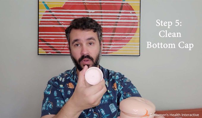 photograph of justin holding a fleshlight cap in his hand with text overlay that reads: step 5 clean bottom cap