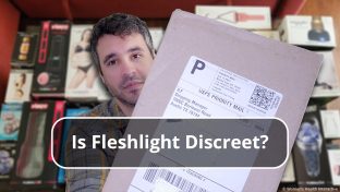 image featuring justin holding his package from fleshlight to display its shipping label with a background featuring a wide selection of fleshlight products blurred in the background