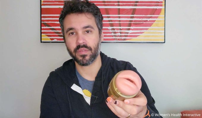 photograph of product tester justin holding the fleshlight quickshot stu mouth/butt stroker with the mouth orifice facing the viewer to display its simple design