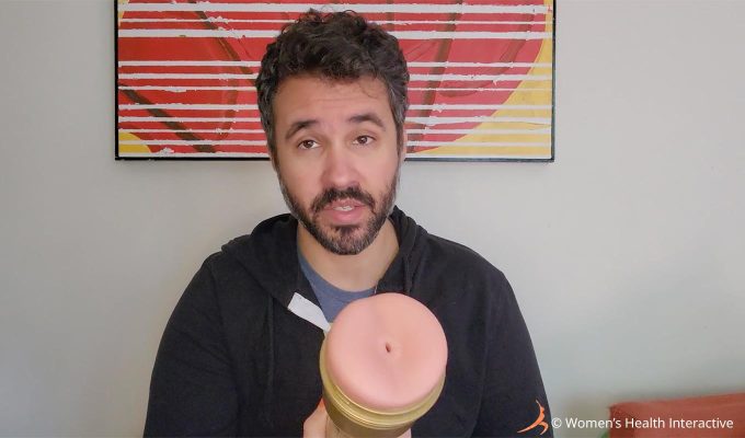 photograph of product tester justin holding the fleshlight stamina training unit butt to display its very tight orifice to the viewer