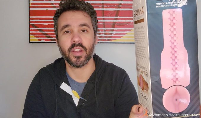 photograph of product tester justin holding the fleshlight stamina training unit butt box to display the design of its sleeve which features a series of tightly-packed nodules throughout, making it the most intense fleshlight sleeve there is