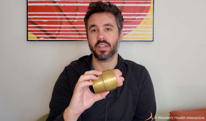 photograph of product tester justin holding the fleshlight quickshot stamina training unit mouth/butt combo stroker in his hand to show its small size from end to end