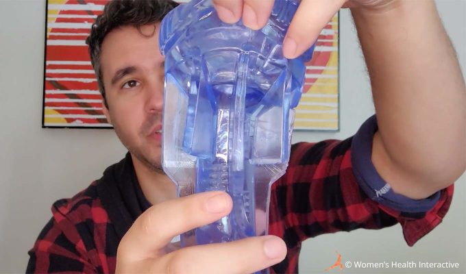 photograph of product tester justin holding the fleshlight turbo core ice sleeve in his hand to examine the texture