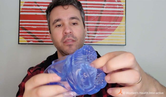 photograph of product tester justin pressing his fingers into the orifice of the clear transparent ice fleshlight turbo thrust