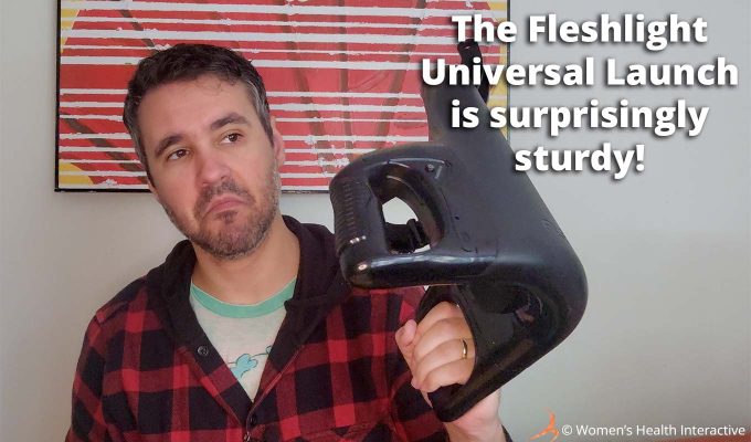 photograph of product tester justin holding the fleshlight universal launch automatic masturbator in one hand with text overlay that reads: the fleshlight universal launch is surprisingly sturdy