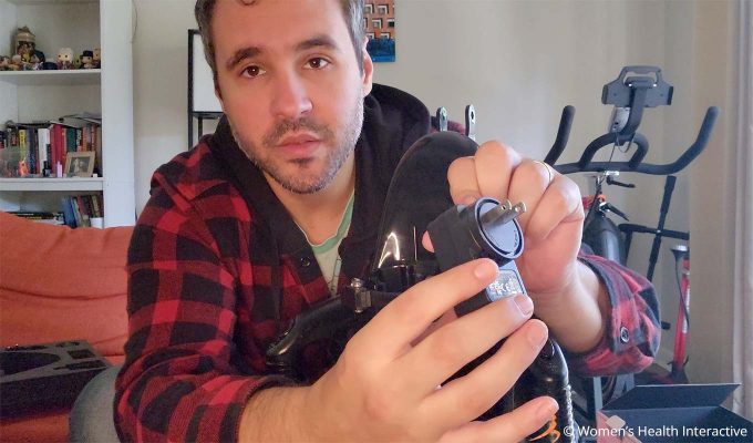 photograph of product tester justin showing one of the power plug options that are included with the fleshlight universal launch automatic masturbator