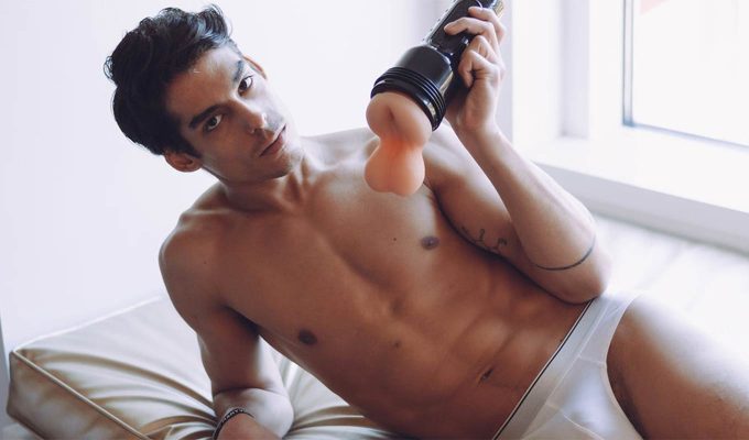 sexy photograph of one of the fleshjack porn actors holding a fleshsack in his hand