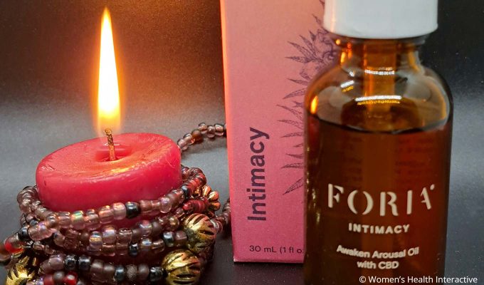 foria awaken arousal oil with cbd bottle and box beside red tealight candle