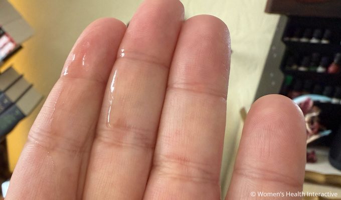 foria awaken arousal oil with cbd on fingers to demonstrate the thin consistency