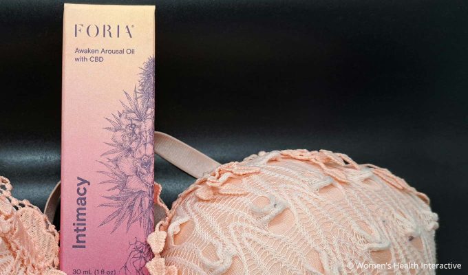 foria awaken arousal oil with cbd box next to lace lingerie