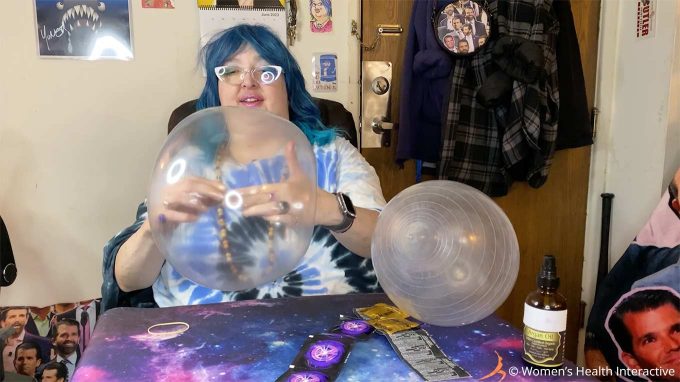 photograph of wednesday pushing the knot through the blown up condom while making her diy fleshlight