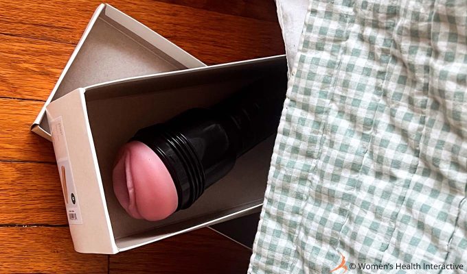 aerial photograph of a fleshlight in a shoebox poking out from beneath a bed