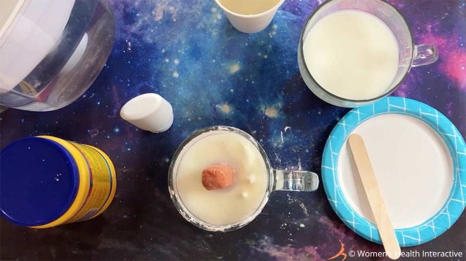 photograph of a hot dog in a tall glass filled with the cornstarch mixture to make the mold for a diy fleshlight 