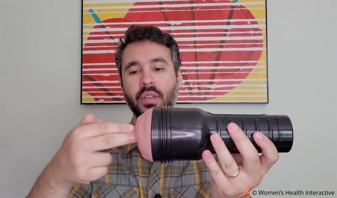 photograph of product tester justin looking at a fleshlight while inserting his fingers into the orifice