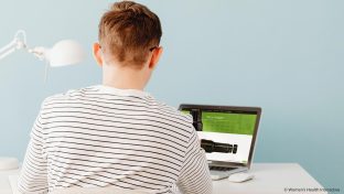 rear view photograph of a teenage boy looking at a fleshlight on a laptop screen