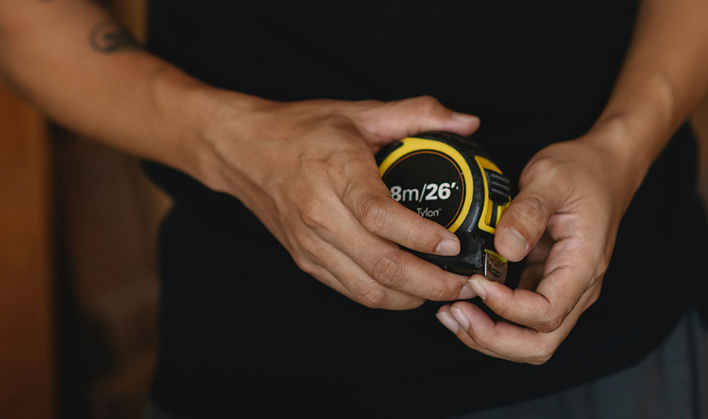 Closeup Photograph Of Man Holding Measuring Tape Near Waist