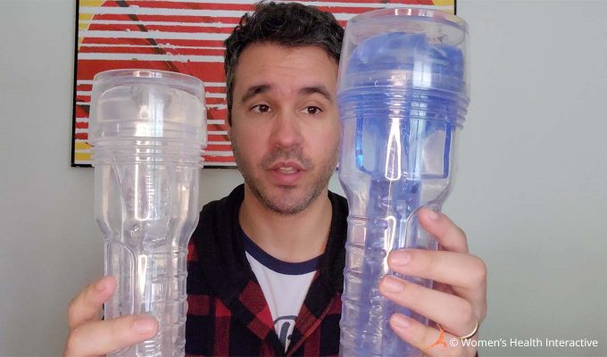 photograph of product tester justin holding two different clear and transparent fleshlights, one in either hand, as part of the testing process