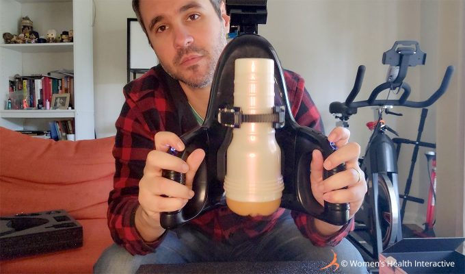 photograph of product tester justin holding the fleshlight universal launch to display the controls on the handles and how easy they are to use intuitively 