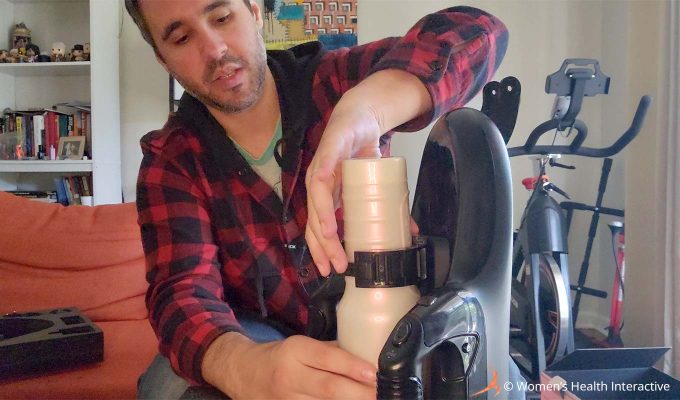 photograph of product tester justin adjusting a full-sized pornstar fleshlight girl in the unit's latch while looking at the device as though considering how safe it is to use