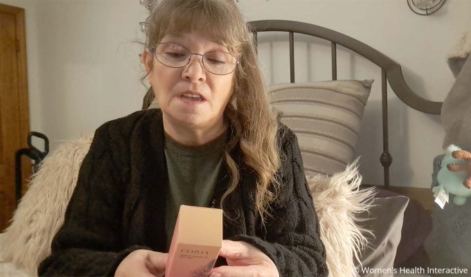 product tester edwina reading the back of the box of foria awaken arousal oil with cbd