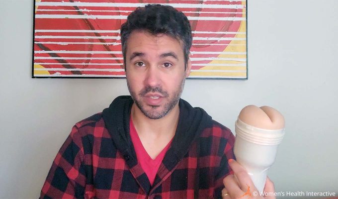 photograph of product tester justin holding the violet myers ahegao anal fleshlight in his hand with an inquisitive expression as though questioning its safety