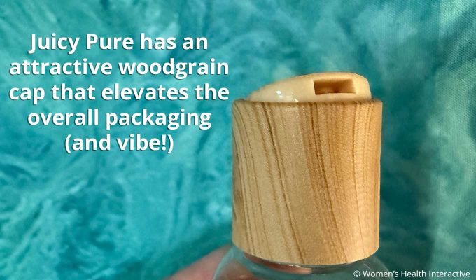 close up view of the wood-like cap on a bottle of foria juicy pure lube
