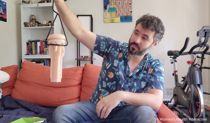 photograph of justin holding the fleshlight hang dry with a sleeve attached to it