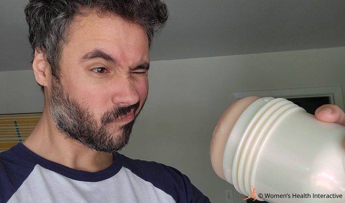 photograph of product tester justin squinting as he looks inside of the riley reid utopia fleshlight