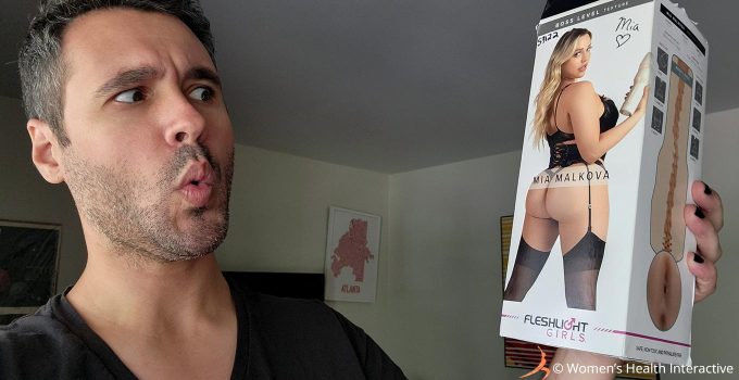 photograph of justin making an "ooooh" expression while looking at the mia malkova boss level fleshlight girl box