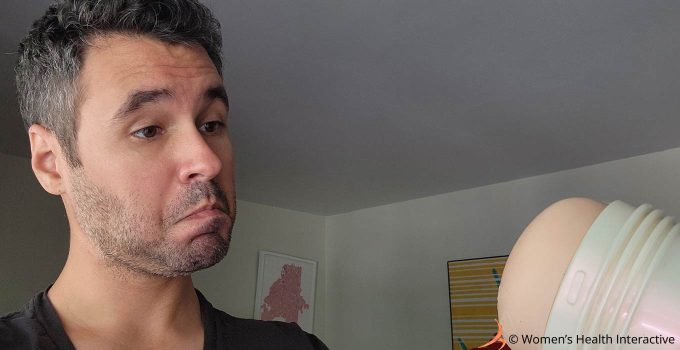 photograph of justin making a quizzical face while looking at the mia malkova boss level anal pornstar fleshlight girl held in his hand