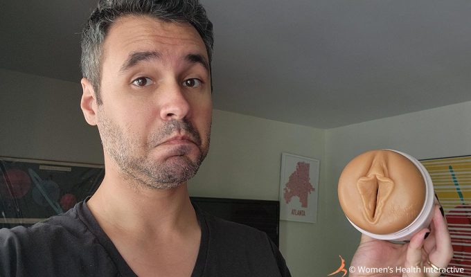 photograph of justin holding the autumn falls cream vulva fleshlight in his hand while making a playful face