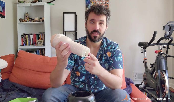 photograph of justin holding a fleshlight with the cap off and pointing at the open end while talking about drying methods