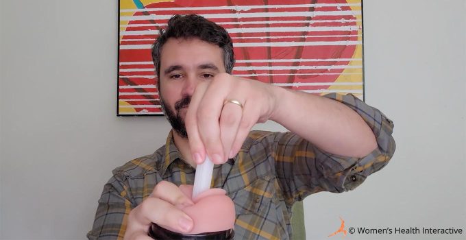photograph of product tester justin removing the shipping stick from the sleeve of a fleshlight