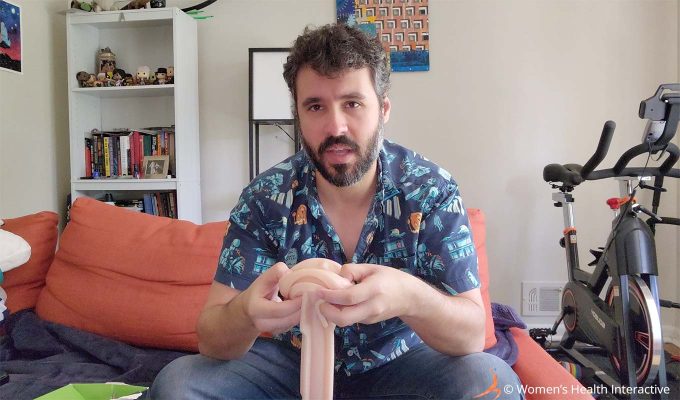 photograph of justin holding a fleshlight sleeve and stretching the orifice slightly to show the inside