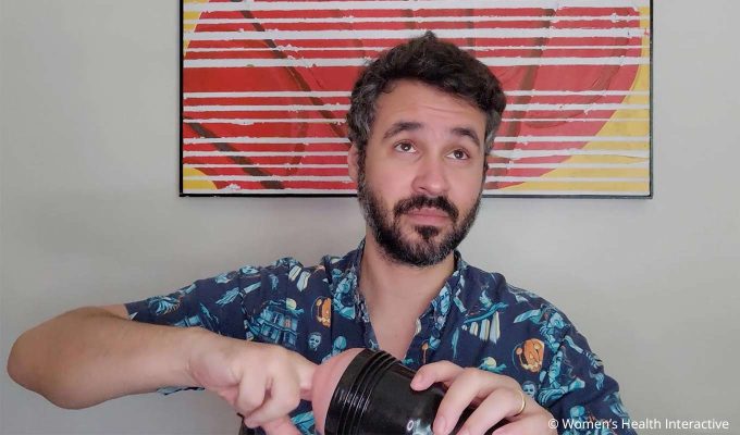 photograph of product tester justin feeling the inside of a fleshlight's materials with an unsure expression on his face