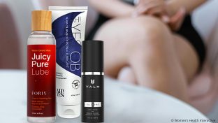 juicy pure water-based lube, ah yes ob oil-based lube, and valm silicone lube on a marble table top with a woman's crossed legs in the distant background
